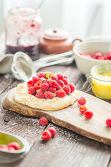 Homemade Cake Pavlova with Whipped Cream, Raspberry Jam and Fresh Raspberries