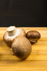 mushroom champignons on a wooden Board