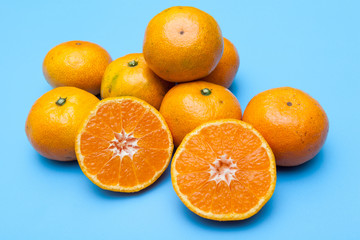 fresh and ripe oranges on blue backgrounds