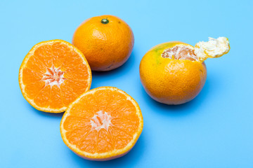 fresh and ripe oranges on blue backgrounds