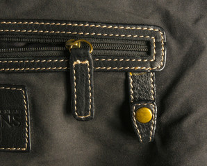 seams on leather hand bag