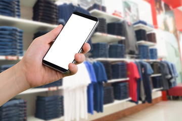 human hand hold smartphone, tablet, cell phone with blurry Cloth