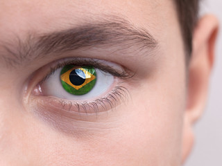 Obraz premium National flag of Brazil on a young boys iris