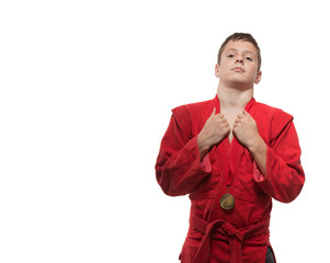 Sportsman boy brunette in a red kimono on a white background