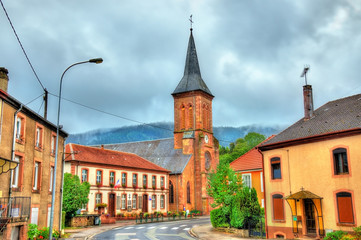 Fototapeta na wymiar La Petite-Raon, town hall and the church. Vosges Department, France