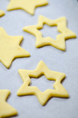 Christmas food background with cookies molds and flour. Baking Christmas cookies - table with star snowflake cookie.