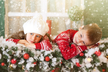 Children girl and boy waiting for Christmas, winter holidays