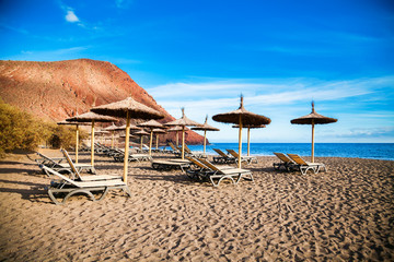 chaise-longues and sun umbrellas in Playa de la Tejita