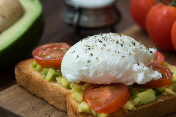 Toast with avocado and egg cooked in olive oil