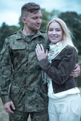 Fototapeta premium Soldier embracing his smiling wife