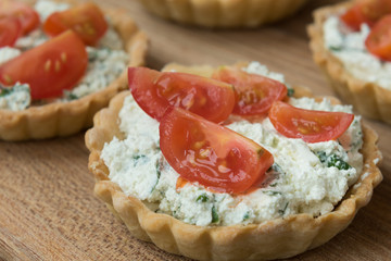 Homemade tartlet with feta, spinach and cherry tomatoes