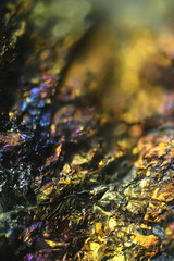 Microscope image of colorful copper ore. This is copper sulphide called Chalcopyrite, main industrial copper ore.