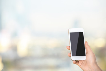 Woman holding blank smartphone