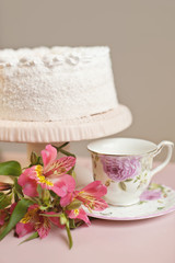 Homemade sweet pie with white cream on pink table.