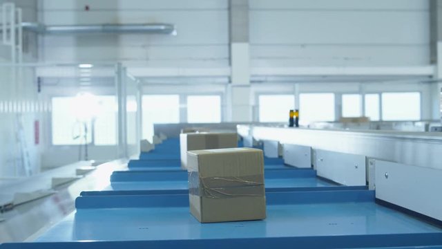 Parcels are Moving on Belt Conveyor at Post Sorting Office. Box POV. Time-Lapse. Shot on RED Cinema Camera in 4K (UHD)