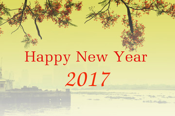 background of 2017 happy new year with red flamboyant and city building