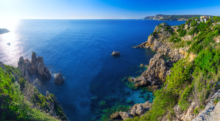 Landscape of beach in close bay with crystal clear azure water.