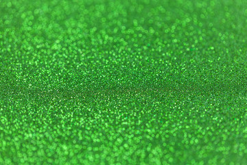 Fototapeta premium Green sparkling background from small sequins, closeup. Brilliant backdrop