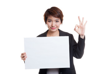 Naklejka premium Young Asian business woman show OK with white blank sign.