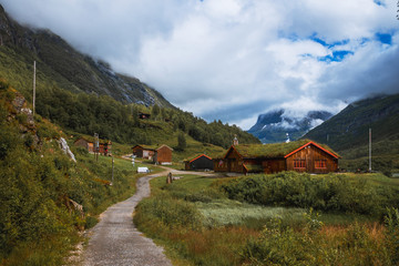 Fototapeta na wymiar Small village of Innerdalen valley with clouds, Norway