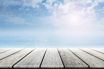 Empty old wooden table with ocean and blue skies background blurred. Concept Summer, Beach, Sea, Ocean, Relax.