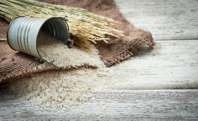 white rice and paddy pile on wood background,Selective focus