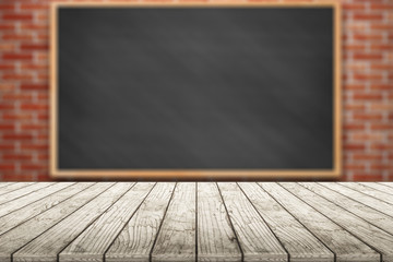 Empty wooden table with chalkboard in classroom background blurred.