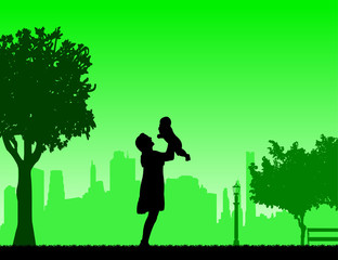 Fototapeta na wymiar Mother plays with her child in the park, one in the series of similar images silhouette