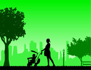 Naklejka na ściany i meble Pregnant woman walking with baby on a tricycle in park, one in the series of similar images silhouette