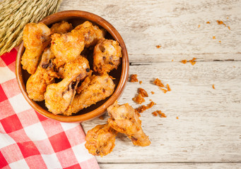 Fried crispy chicken wings on a wood table