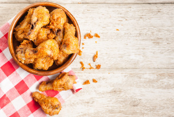 Fried crispy chicken wings on a wood table