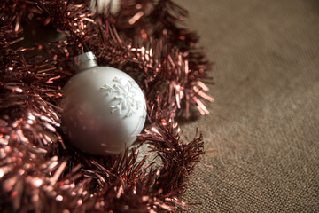 Christmas decorations: single silver ball with white snowflake and bronze tinsel