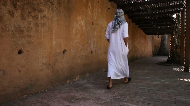 Young arabian man walks