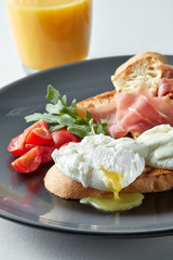 Eggs Benedict with ham and tomato