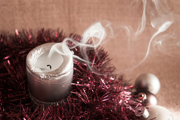 blown out Christmas candle with white wisps of smoke