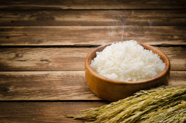 Cooked rice and paddy rice on wood