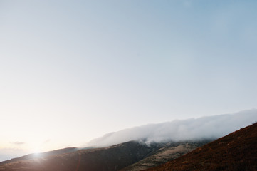 Amazing picturesque landscape of Carpathian mountains on fog and