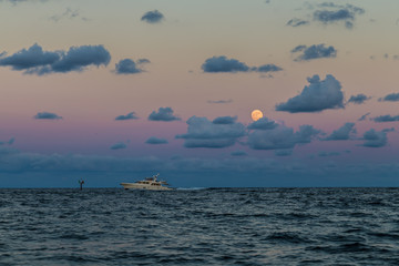 Obraz premium Moon and Fishing boat/Moonrise over the Atlantic ocean.