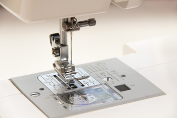 The sewing on the sewing machine turquoise fabric