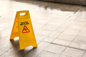 Close up yellow caution wet floor sign with copy space for text.