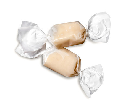 Caramel toffee candy in white package on white background