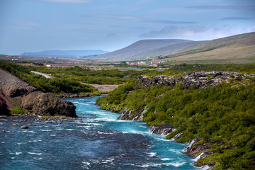 Fototapeta premium Hraunfossar series of waterfalls formed by rivulets streaming ov
