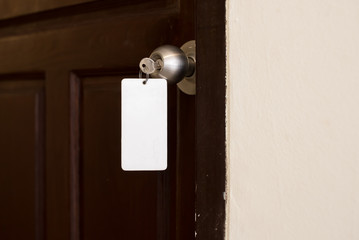 house key with hotel card and hotel door