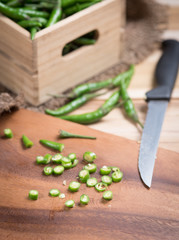 Green peppers on wood background