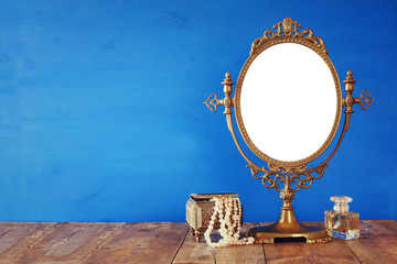 Fototapeta na wymiar Old vintage mirror and woman toilet fashion objects