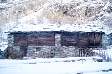 chalets, mountain house, with snow and snow-covered trees. colorful trees and ancient wooden houses