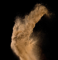 Sandy explosion isolated on over dark background,