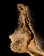 Sandy explosion isolated on over dark background,