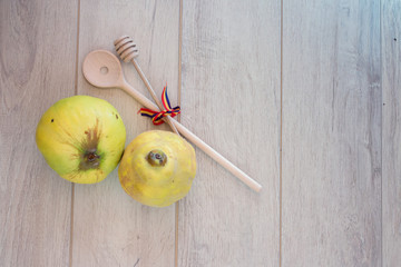 Quince and wooden spoon on wood background