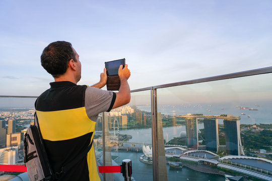 Male tourist taking picture of Singapore